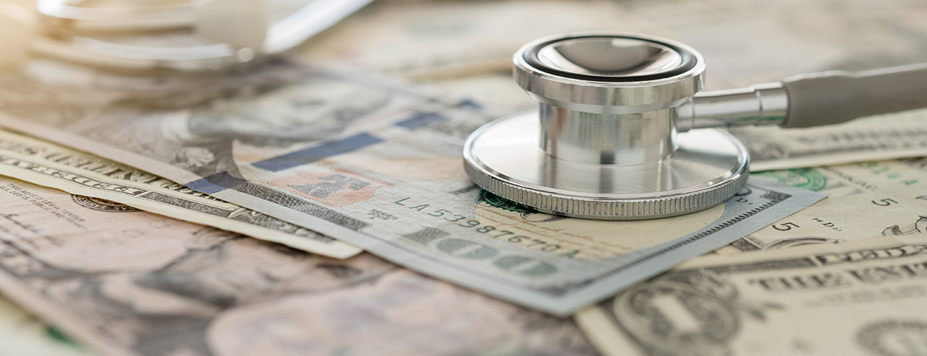 A stethoscope on top of money