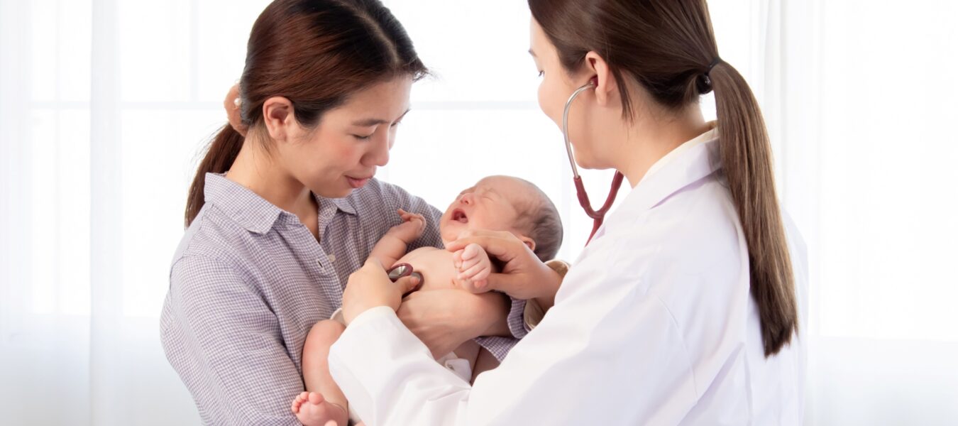Mother and newborn being seen by doctor