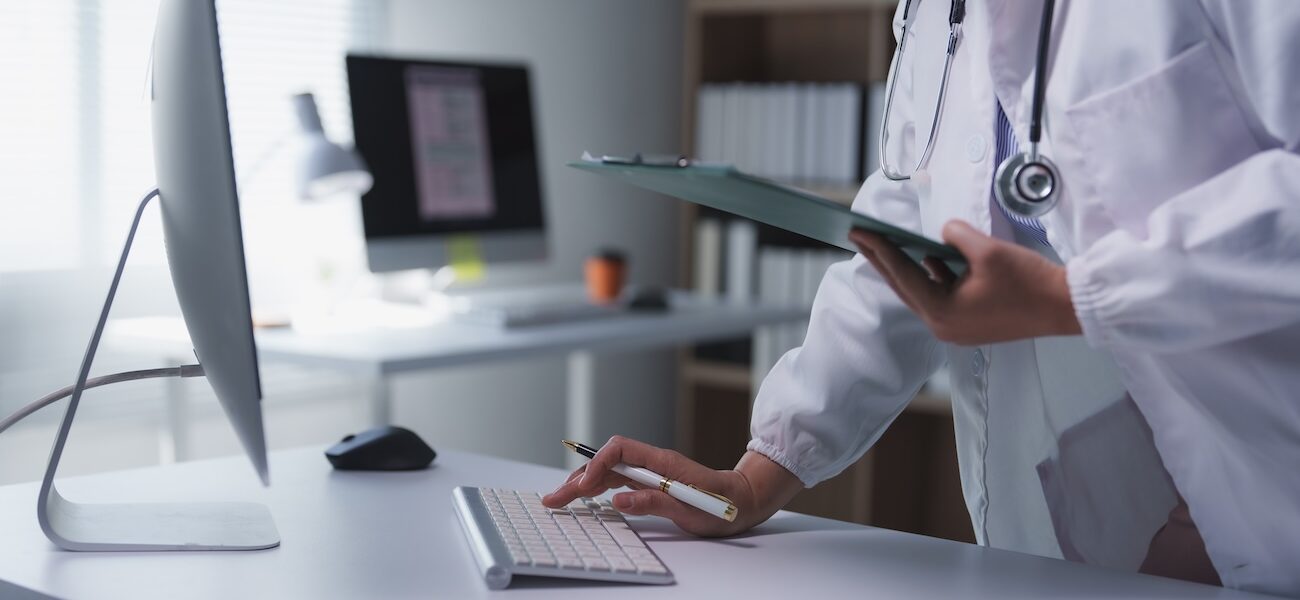 physician inputting information into computer