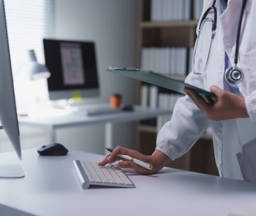 physician inputting information into computer