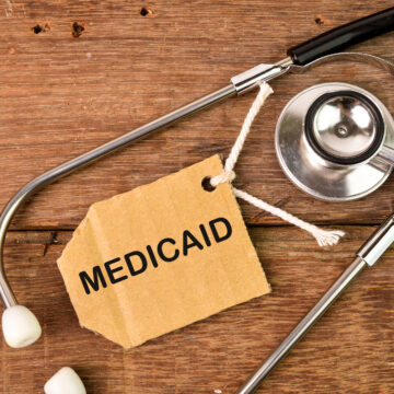 Top view of stethoscope and label tag written with text MEDICAID.
