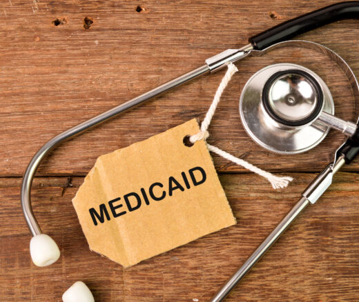 Top view of stethoscope and label tag written with text MEDICAID.
