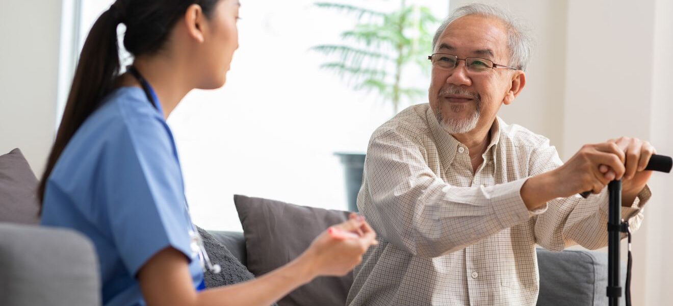 Elderly man receiving care from female physician in a nursing home setting.