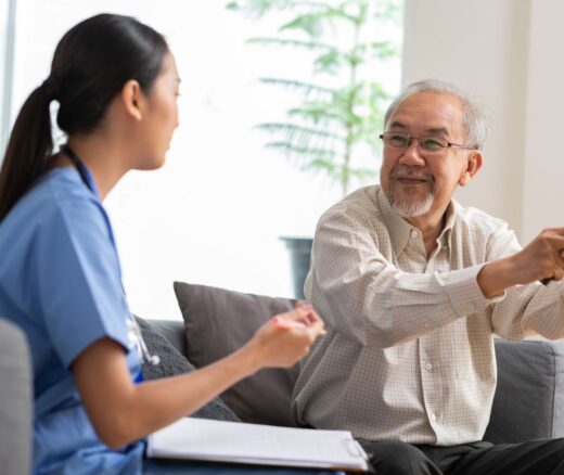 Elderly man receiving care from female physician in a nursing home setting.