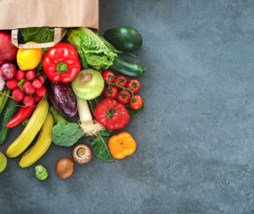 Shopping bag full of fresh vegetables and fruits.