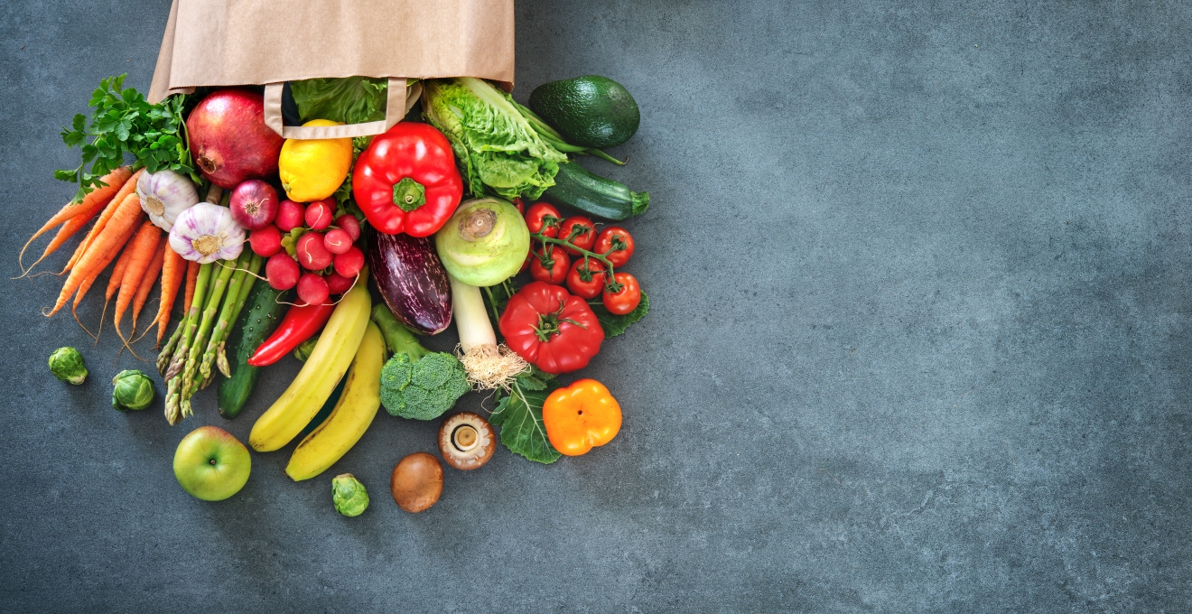 Shopping bag full of fresh vegetables and fruits.