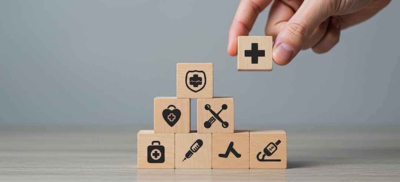 wooden blocks with health care symbols stacked in a pyramid