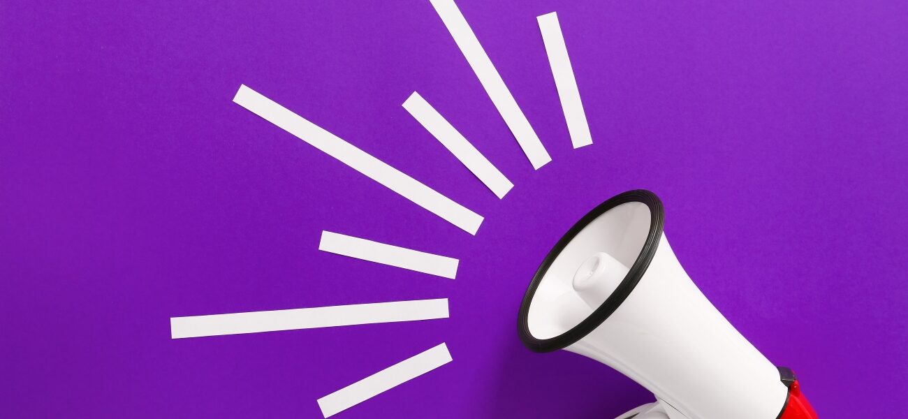 Modern megaphone on purple background