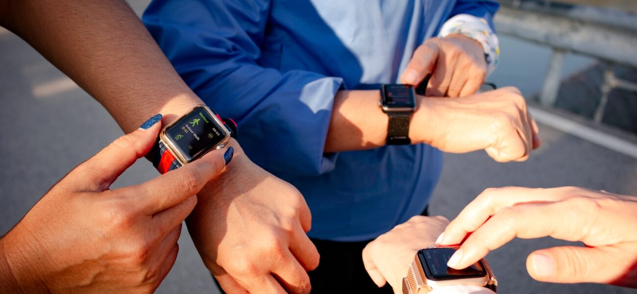 Group of people using fitness trackers.