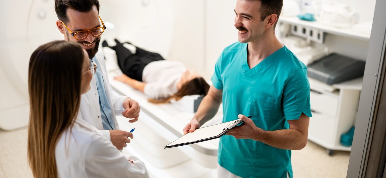 Three clinicians huddled and smiling.