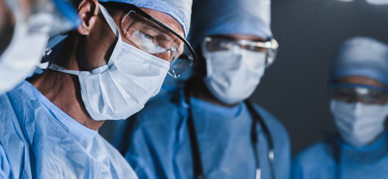 Concentrated surgeons operating patient in operating theatre.