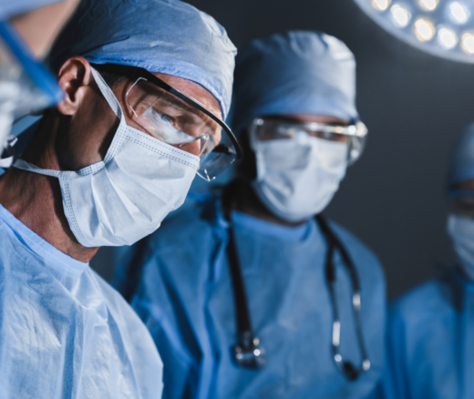 Concentrated surgeons operating patient in operating theatre.