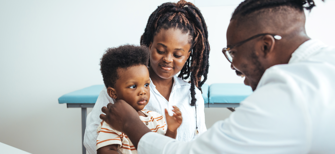 An African-American toddler and his mother at the pediatrician's office.