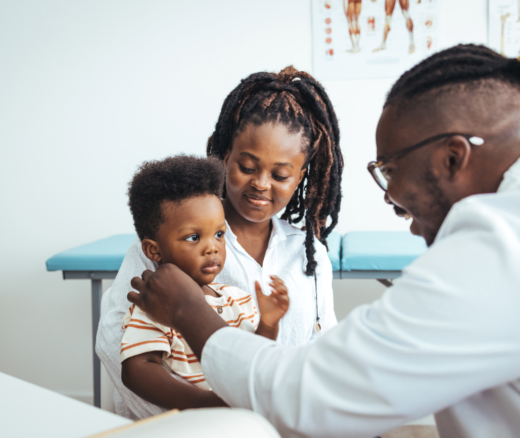 An African-American toddler and his mother at the pediatrician's office.