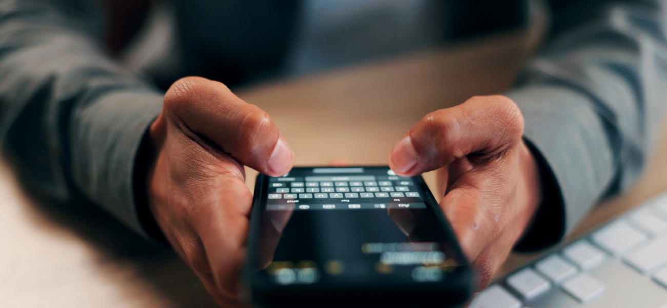 A person typing a text message on a smartphone.