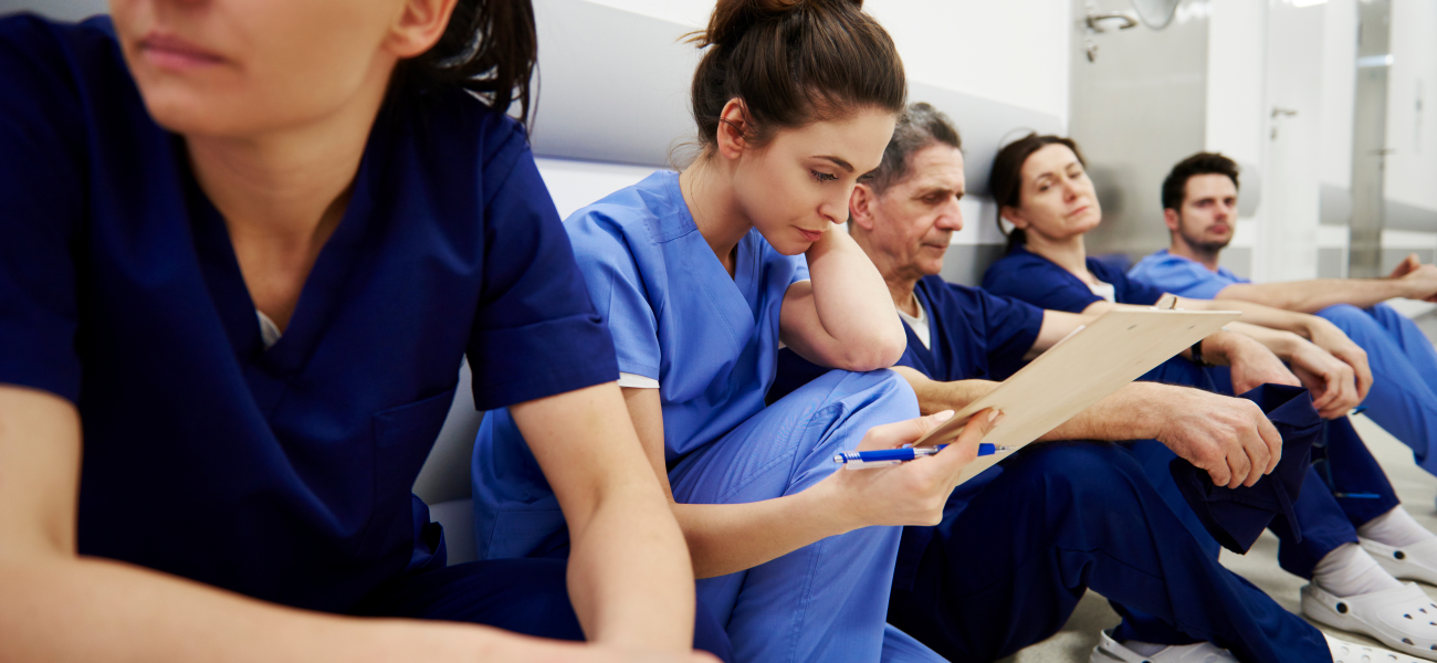 A group of nurses sitting in a hospital hallway