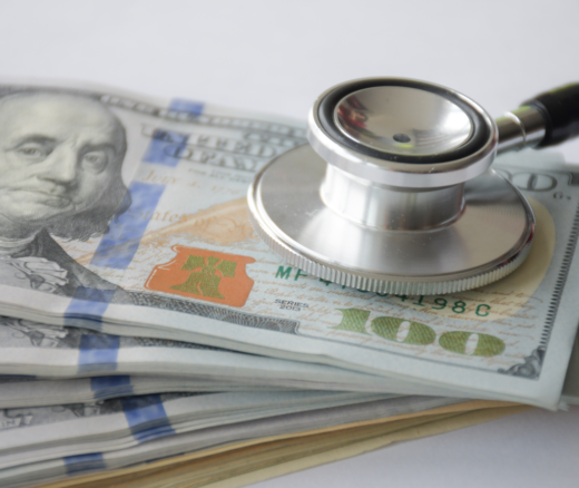 A stethoscope placed on top of cash