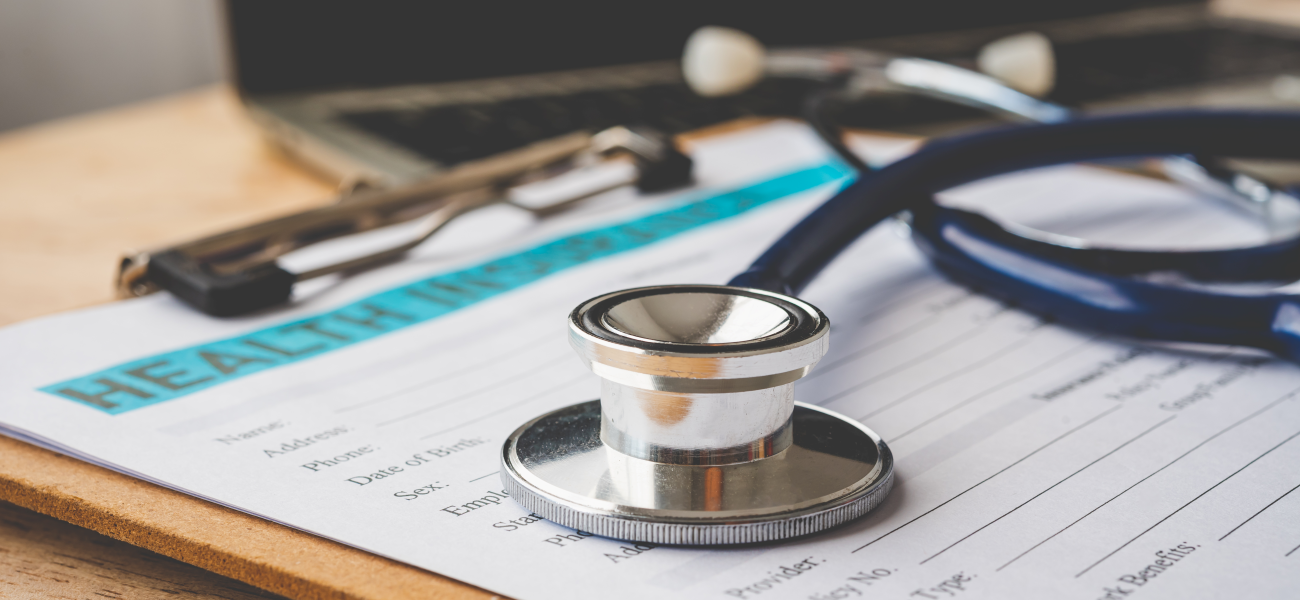 A stethoscope on top of a clipboard